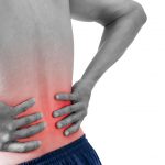 Man clutches his aching back as a a result of lower back pain treatable by chiropractic in Waterloo